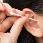 Woman cleaning ear